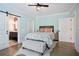Inviting bedroom featuring hardwood floors, a patterned bedspread and an ensuite bathroom at 2578 Middle Coray Cir, Marietta, GA 30066
