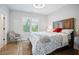 Bedroom with wood floors, large bed, and natural light streaming through shuttered windows at 2578 Middle Coray Cir, Marietta, GA 30066