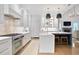 Bright kitchen with white cabinetry, stainless steel appliances, and a large center island with seating at 2578 Middle Coray Cir, Marietta, GA 30066