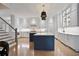 Spacious kitchen featuring a center island, white cabinets, modern appliances and an open staircase at 2578 Middle Coray Cir, Marietta, GA 30066
