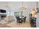 Open-concept living and dining area with a stone fireplace, modern lighting, and neutral tones at 2578 Middle Coray Cir, Marietta, GA 30066