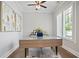 Bright home office with hardwood floors, a modern desk, and natural light from shuttered windows at 2578 Middle Coray Cir, Marietta, GA 30066