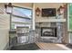Outdoor kitchen with stainless steel grill, stone surround, and a built-in fireplace at 2578 Middle Coray Cir, Marietta, GA 30066