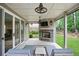 Inviting screened-in porch with stone fireplace, outdoor seating, ceiling fans, and serene backyard views at 2578 Middle Coray Cir, Marietta, GA 30066