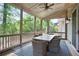 Inviting screened porch with outdoor dining area and views of lush greenery at 2578 Middle Coray Cir, Marietta, GA 30066