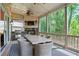 Spacious screened porch featuring a dining table, fireplace, and an outdoor kitchen at 2578 Middle Coray Cir, Marietta, GA 30066