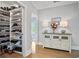 Custom shoe closet with shelves for storage adjacent to a hallway with console table and hardwood floors at 2578 Middle Coray Cir, Marietta, GA 30066