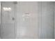 Luxurious shower with elegant white tile, a built-in niche, and sleek glass enclosure at 2578 Middle Coray Cir, Marietta, GA 30066