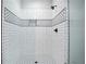 White tiled shower with black accents and glass door at 2578 Middle Coray Cir, Marietta, GA 30066
