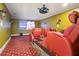 Home theater room with tiered seating, projector screen, and comfortable red reclining chairs for an immersive experience at 2578 Middle Coray Cir, Marietta, GA 30066