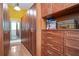 Spacious walk-in closet featuring custom shelving and ample storage with warm wood accents and bright lighting at 2578 Middle Coray Cir, Marietta, GA 30066