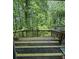 The back deck features striped flooring and overlooks a lush, green landscape at 3739 Jamestown Ct, Doraville, GA 30340