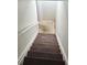 Staircase leading to basement with carpeted steps and freshly painted white walls at 3739 Jamestown Ct, Doraville, GA 30340