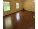 Bedroom with two windows, a ceiling fan, and wood-look floors, providing ample natural light at 3739 Jamestown Ct, Doraville, GA 30340