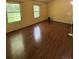 Bedroom featuring hardwood floors, two windows, and a sloped ceiling at 3739 Jamestown Ct, Doraville, GA 30340