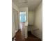 Upper hallway with wood floors leading to rooms with open doorway, staircase, and simple features at 3739 Jamestown Ct, Doraville, GA 30340