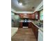 Functional kitchen with brown cabinets, laminate countertops, and stainless steel refrigerator at 3739 Jamestown Ct, Doraville, GA 30340
