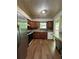 Features wood-look floors, brown cabinets, and white appliances in this kitchen at 3739 Jamestown Ct, Doraville, GA 30340