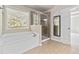 This bathroom features a stand-alone shower, a soaking tub, and a large window at 4840 Shiloh Springs Rd, Cumming, GA 30040