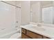 This bathroom features a shower/tub combo with white tile and dark wood vanity at 4840 Shiloh Springs Rd, Cumming, GA 30040