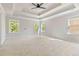 This bedroom features a ceiling fan, neutral paint and carpet, and large windows at 4840 Shiloh Springs Rd, Cumming, GA 30040