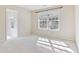 Bedroom with carpet, a ceiling fan, and a large window providing natural light at 4840 Shiloh Springs Rd, Cumming, GA 30040