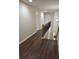 Upstairs hallway with wood flooring and wood and iron railing at 4840 Shiloh Springs Rd, Cumming, GA 30040