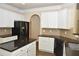 Well-lit kitchen features white cabinetry, dark countertops and black stainless steel appliances at 4840 Shiloh Springs Rd, Cumming, GA 30040