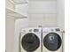 This laundry room features a side-by-side washer and dryer and wire shelving at 4840 Shiloh Springs Rd, Cumming, GA 30040
