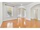 Open living space featuring hardwood floors, neutral walls, and an arched entryway at 4840 Shiloh Springs Rd, Cumming, GA 30040