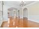 Spacious living room with beautiful hardwood floors, elegant trim, and open archways at 4840 Shiloh Springs Rd, Cumming, GA 30040