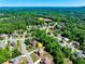 A birds-eye view of a cozy neighborhood nestled amongst lush trees, offering suburban tranquility at 5925 Boulder Bluff Dr, Cumming, GA 30040