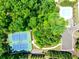 Aerial view of tennis courts, parking lot, pool, and surrounding verdant greenery at 5925 Boulder Bluff Dr, Cumming, GA 30040