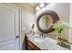 Bathroom vanity with granite counters, framed mirror, and decorative accents at 5925 Boulder Bluff Dr, Cumming, GA 30040
