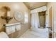 Cozy bathroom featuring a shower-over-tub with stylish neutral tiling and decorative elements at 5925 Boulder Bluff Dr, Cumming, GA 30040