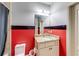 Stylish bathroom features red and gray wall, granite vanity, and modern fixtures at 5925 Boulder Bluff Dr, Cumming, GA 30040