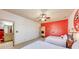 View of bedroom with red accent wall, 2 twin beds, and a glimpse into en suite bathroom at 5925 Boulder Bluff Dr, Cumming, GA 30040