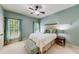 Cozy bedroom with natural light, soft blue walls, and comfortable furnishings at 5925 Boulder Bluff Dr, Cumming, GA 30040