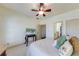 Bright bedroom with white carpet and walls features a tv and doorway to the bathroom at 5925 Boulder Bluff Dr, Cumming, GA 30040