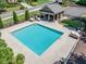 An aerial view of a community pool with a shaded patio and recreational facilities at 5925 Boulder Bluff Dr, Cumming, GA 30040