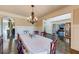 Elegant dining room featuring a decorative chandelier, hardwood floors and direct access to the living spaces at 5925 Boulder Bluff Dr, Cumming, GA 30040
