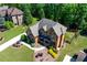 Imposing brick home boasting a stone-clad facade, shutters, professional landscaping, and pristine lawn at 5925 Boulder Bluff Dr, Cumming, GA 30040