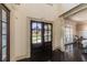 Grand foyer with dark hardwood floors and a view of the front yard through double doors at 5925 Boulder Bluff Dr, Cumming, GA 30040