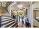 Grand foyer with hardwood staircase, coffered ceilings and views into the living room and main bedroom at 5925 Boulder Bluff Dr, Cumming, GA 30040
