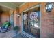 Inviting front door with decorative wreaths, flanked by sconces, and a cozy porch area at 5925 Boulder Bluff Dr, Cumming, GA 30040