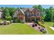 Beautiful two-story brick home with a well-manicured lawn and professional landscaping at 5925 Boulder Bluff Dr, Cumming, GA 30040