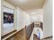 Hallway with hardwood floors leads to a rec room with movie-themed decor at 5925 Boulder Bluff Dr, Cumming, GA 30040