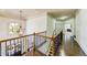 Open hallway overlooking the foyer, featuring hardwood floors and an elegant chandelier at 5925 Boulder Bluff Dr, Cumming, GA 30040