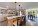 Gourmet kitchen features a large center island with seating, custom cabinets and modern stainless steel appliances at 5925 Boulder Bluff Dr, Cumming, GA 30040