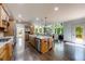 Gourmet kitchen boasts a large center island, modern appliances, custom cabinets and views of the living room at 5925 Boulder Bluff Dr, Cumming, GA 30040